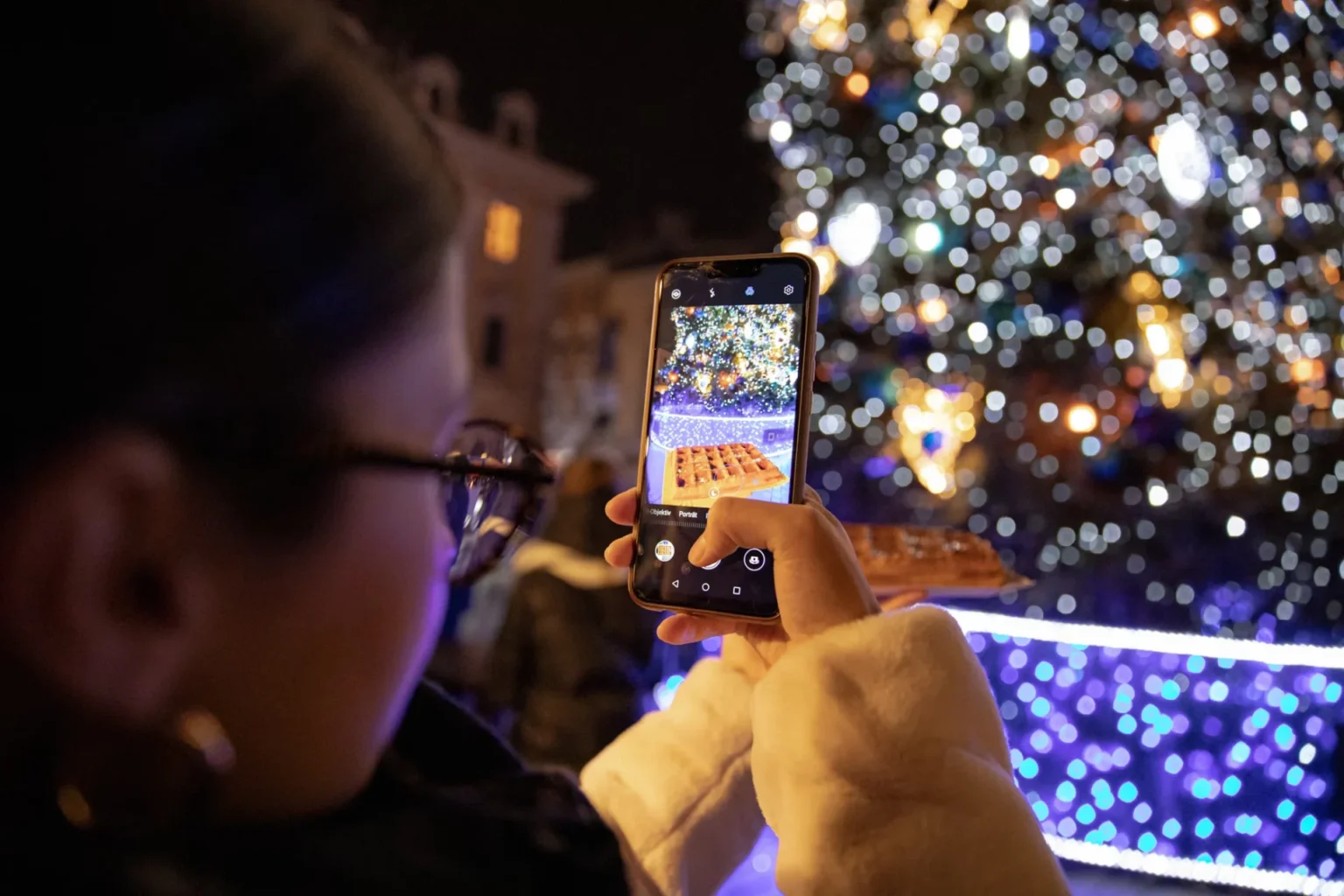 woman taking picture of food