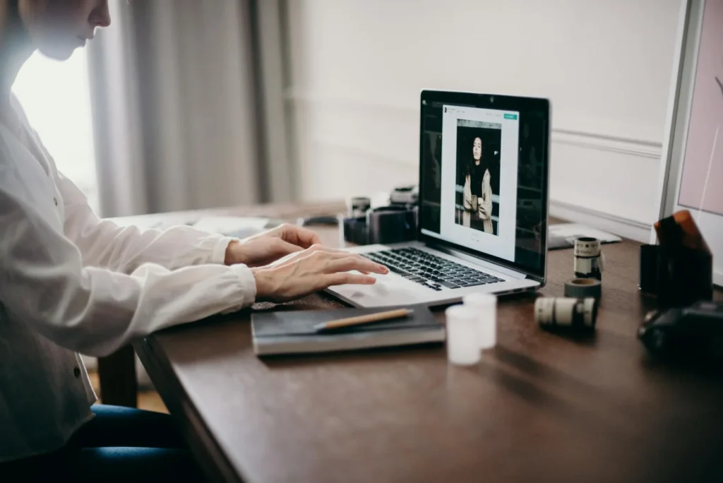 From Photoshop Purgatory to AI Paradise: How Face-Swapping Technology Rescued My Visual Content Workflow woman using laptop