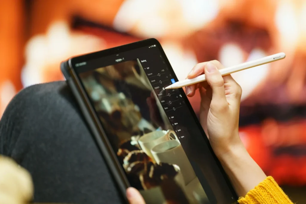From Photoshop Purgatory to AI Paradise: How Face-Swapping Technology Rescued My Visual Content Workflow woman working on i pad