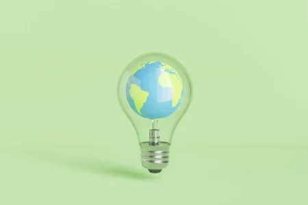 Trump Officials Tour Alaska to Promote Energy Growth and Deregulation A bulb with Earth inside of it.