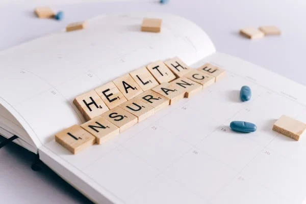 Health insurance written with scrabble tiles
