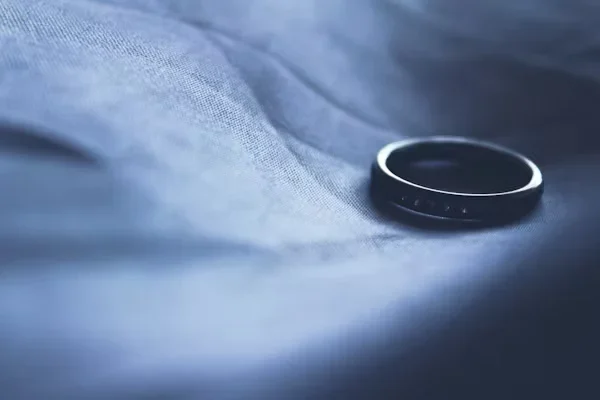 2025’s New Jewelry Trends to Watch Out For: Functional Luxe a black ring on piece of cloth 2