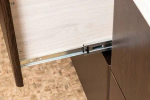 a brown cabinet with sliding hinges
