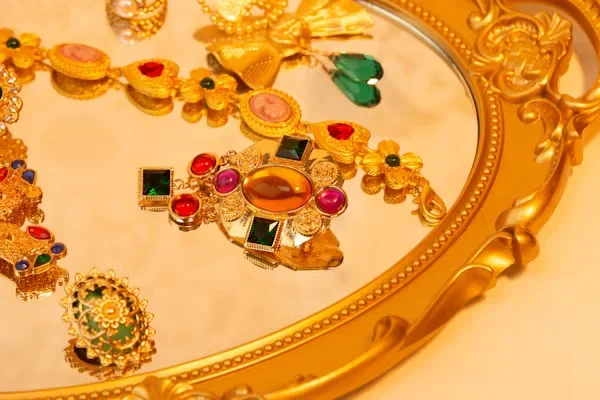 2025’s New Jewelry Trends to Watch Out For: Functional Luxe a colorful stone jewelry on mirror