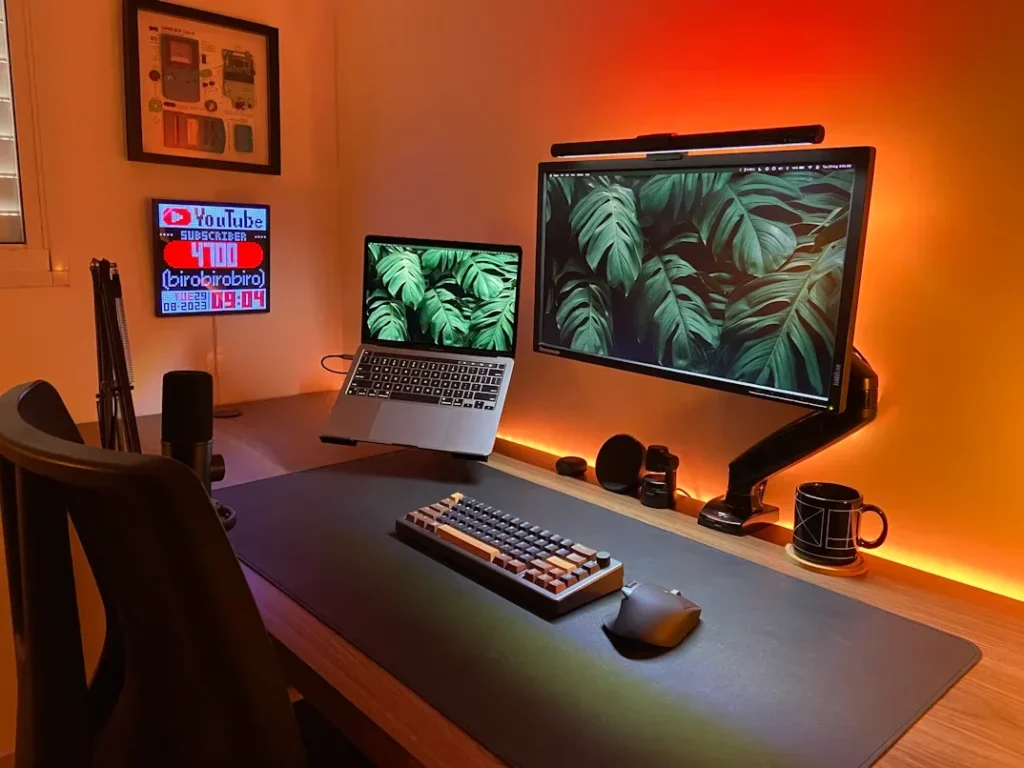 Home Office Hacks for Remote Workers Living With Roommates a desk with a laptop and a monitor on it