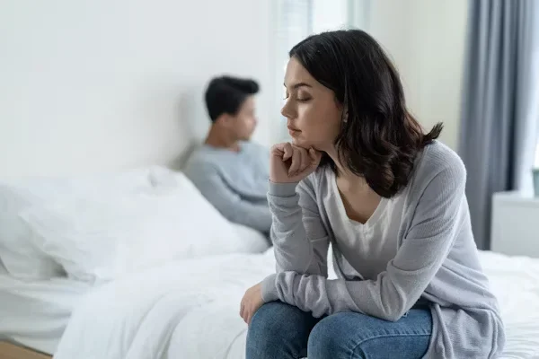 7 Signs It Might Be Time to Seek Counselling Support in Your Relationship a distress woman sitting on bed