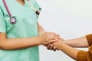 a doctor and patient holding hands