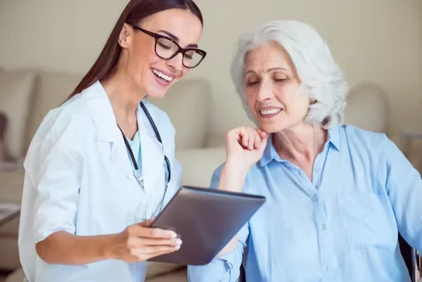 The Role of Nurse Practitioners: Raising the Standard of Patient Care Facility-Wide a doctor standing besides an elderly woman