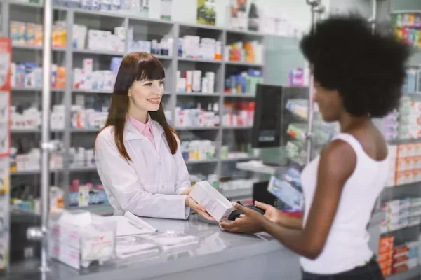 a female doctor giving medicines to her patient