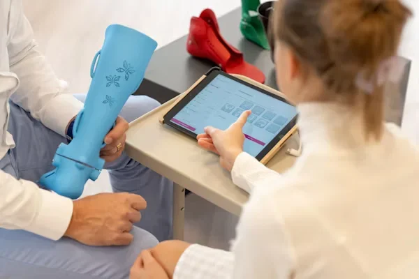 Your Guide to Reimagining Patient-Centered Care for Tomorrow’s Needs A girl pointing at a tablet