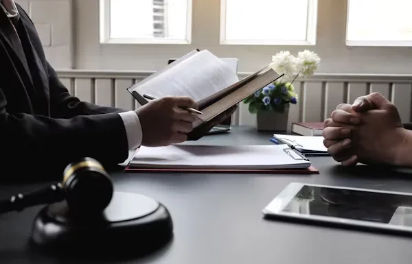 Key Benefits Lawyers Bring to Complex Legal Situations a man holding a book in his hands