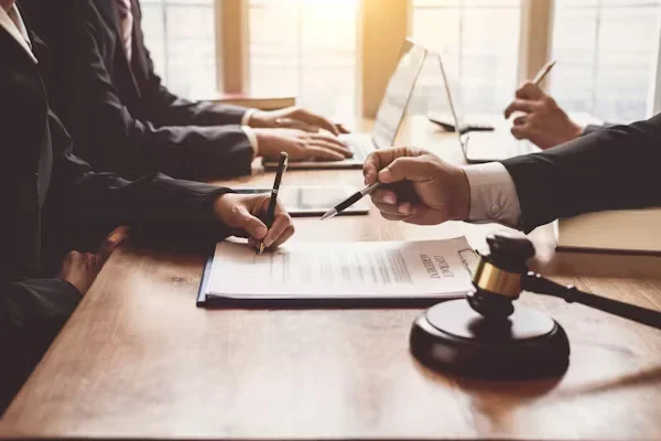 Key Benefits Lawyers Bring to Complex Legal Situations a person holding pen in his hands