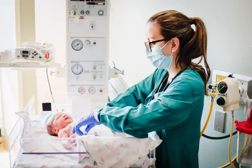 a nurse examining a infant