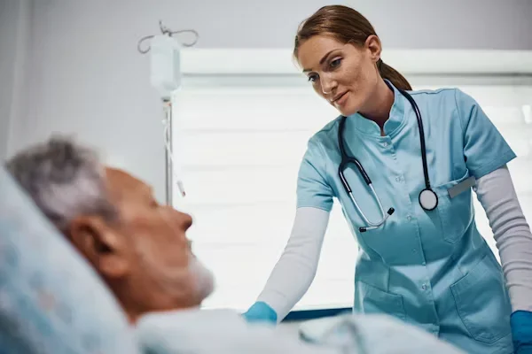 The Role of Nurse Practitioners: Raising the Standard of Patient Care Facility-Wide a nurse stalking to her patient