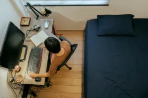 a person sitting at desk working on laptop