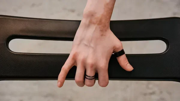 2025’s New Jewelry Trends to Watch Out For: Functional Luxe a person with their hand on chair 1