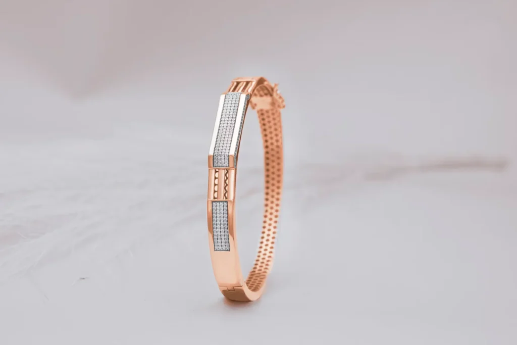 2025’s New Jewelry Trends to Watch Out For: Functional Luxe a rose gold bracelet on white cloth