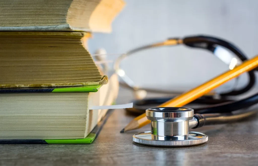 The Role of Nurse Practitioners: Raising the Standard of Patient Care Facility-Wide a stethoscope sitting on top of a pile of books