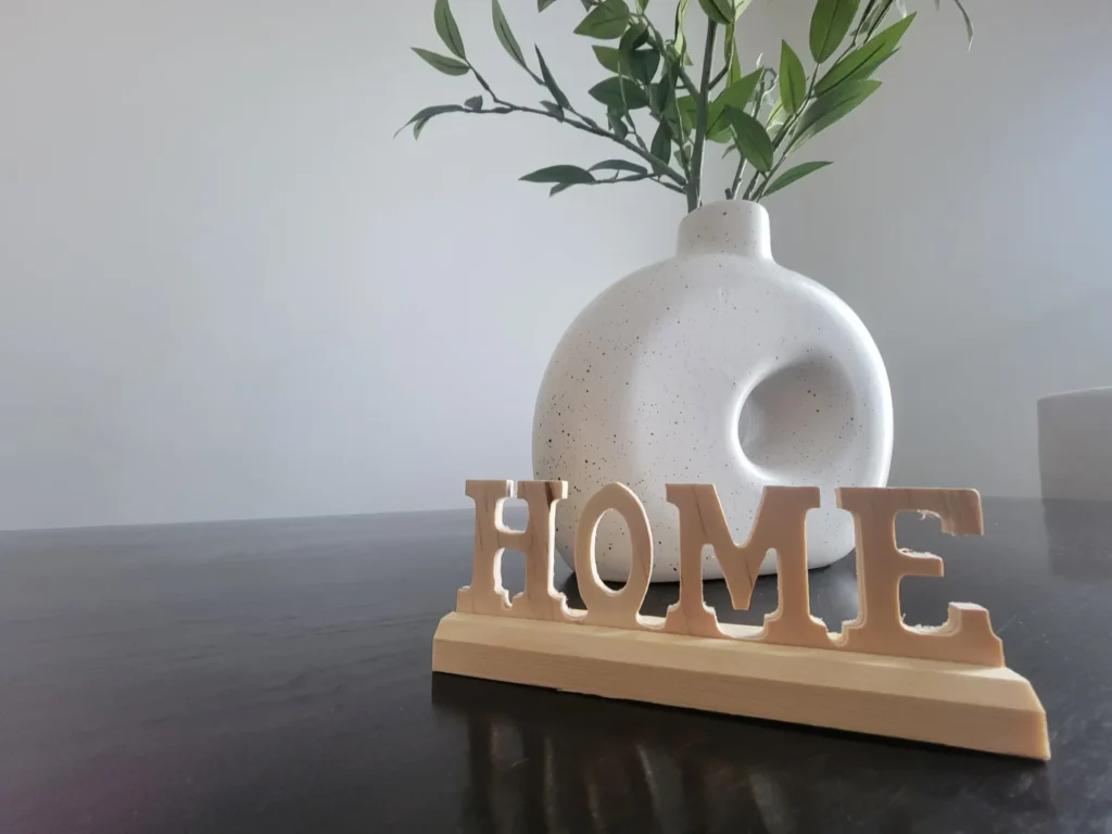 a white vase with a plant in it