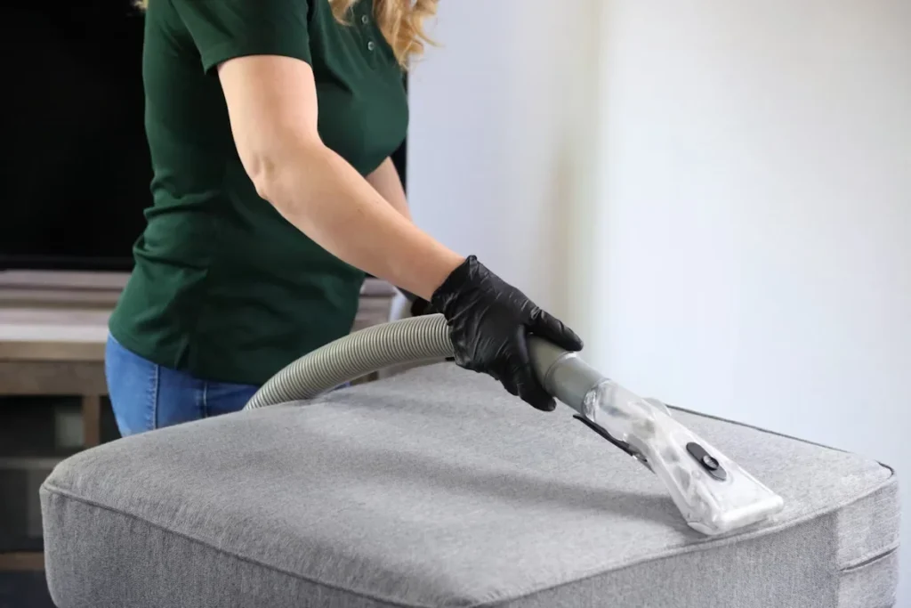 Sofa Bed Solutions For Modern Living: Smart Ideas For Small Spaces a woman holding vacuum cleaning couch