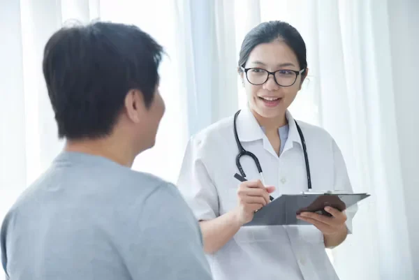 Your Guide to Reimagining Patient-Centered Care for Tomorrow’s Needs female doctor talking to her patient