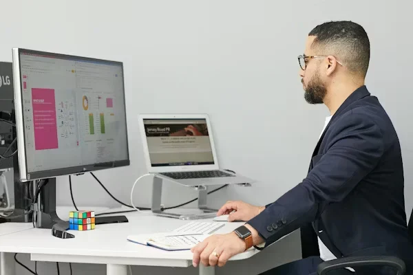 What Is Proposal Automation? A man sitting at desk using laptop