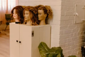 mannequin heads sitting on top of a cabinet