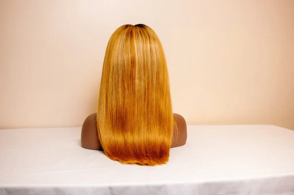 Transform Your Look with Wigs, Bundles, and Hair Toppers mannequin wearing orange hair wig