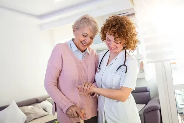 Your Guide to Reimagining Patient-Centered Care for Tomorrow’s Needs nurse helping senior adult to walk