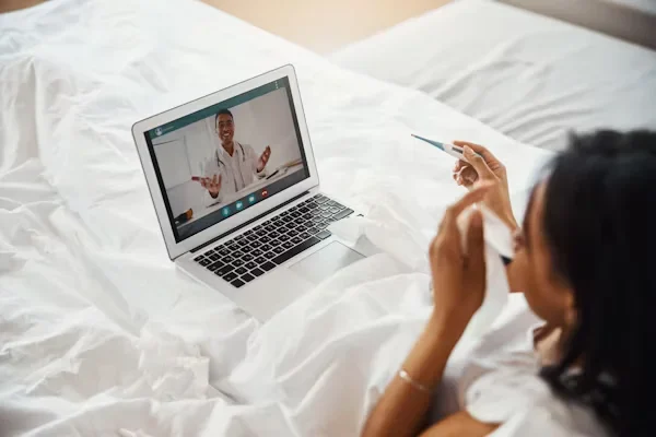 Your Guide to Reimagining Patient-Centered Care for Tomorrow’s Needs patient talking to her doctor on laptop
