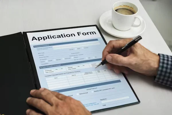 person filling application form