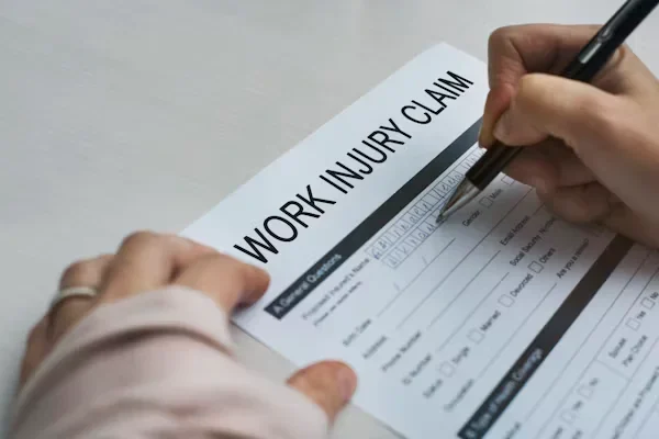 Person filling Work injury claim form
