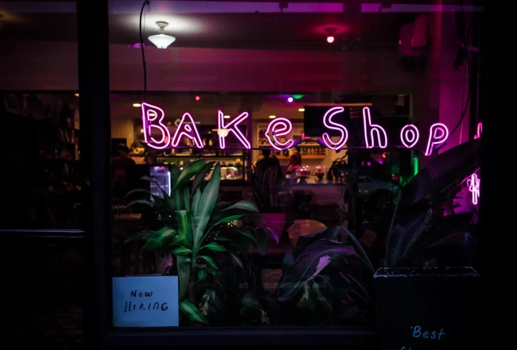 Franchise vs. Independent Bakery: Which is Right for You? purple bake shop signage at night