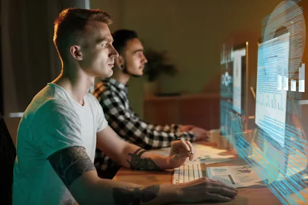 How Can a Virtual Assistant Simplify Local News Marketing? two men working on laptop
