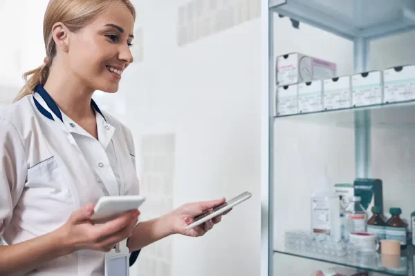 woman standing in front of medicine shelf