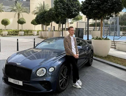 A man standing next to car