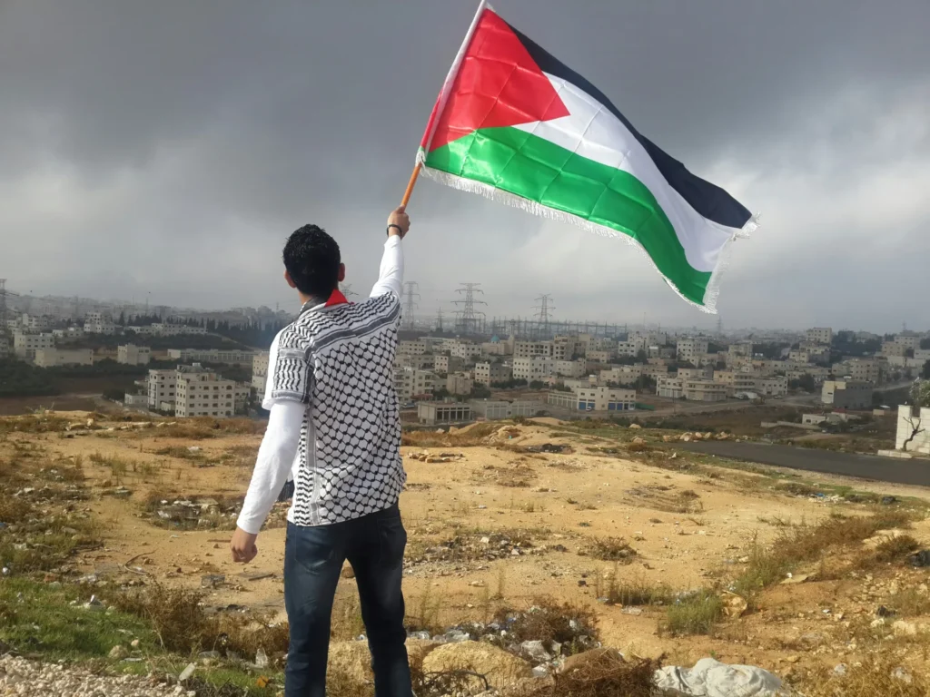 A man holding a Palestinian flag.