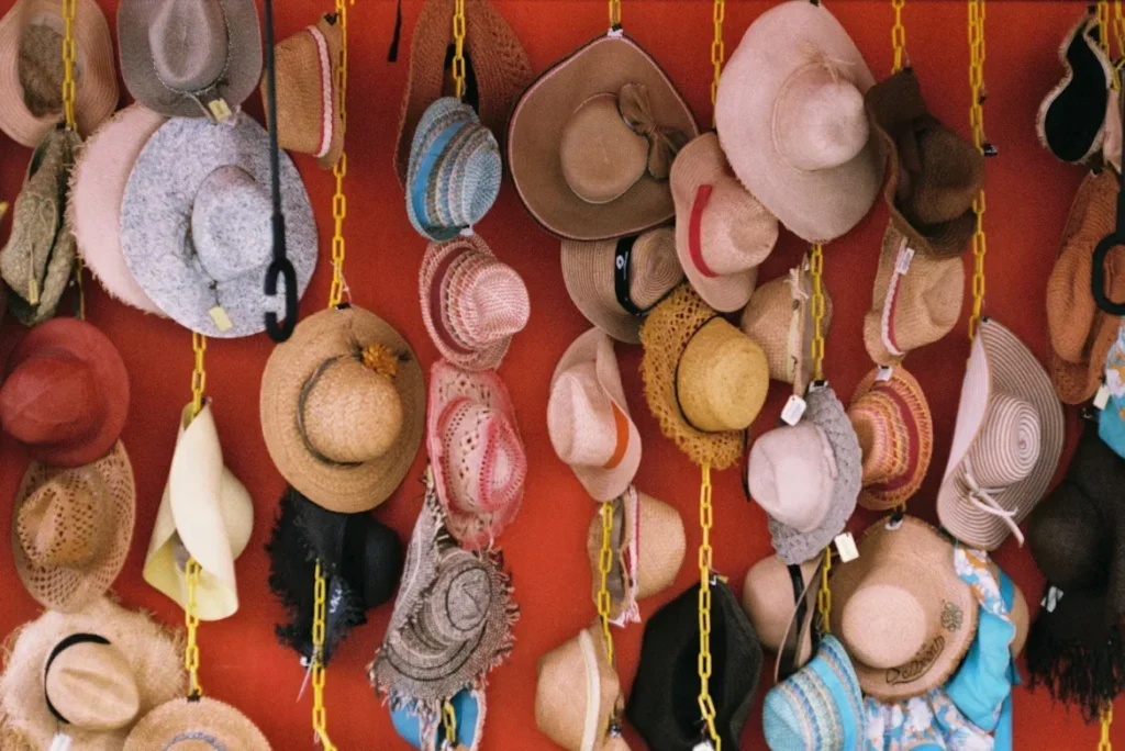 How to Source from Hat Manufacturers in China a bunch of hats hanging up on wall