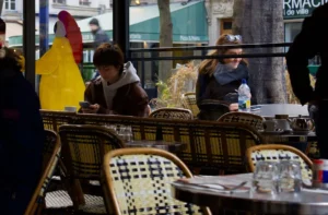 a group of people sitting at table in a restaurant