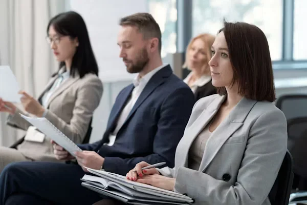 What to Wear to Networking Events Without Looking Overdressed or Underwhelming a group of people sitting next to each other