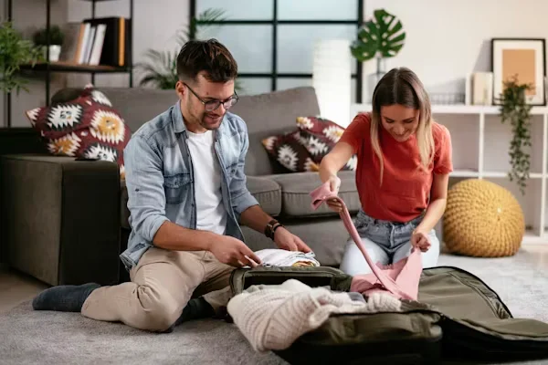 Gift Ideas for Travelers This Summer: 10 Gifts They'll Use a man and woman packing luggage bags