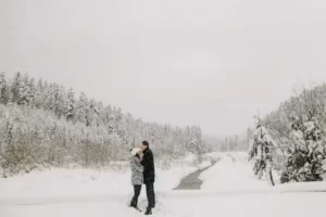 a man and woman standing in snow