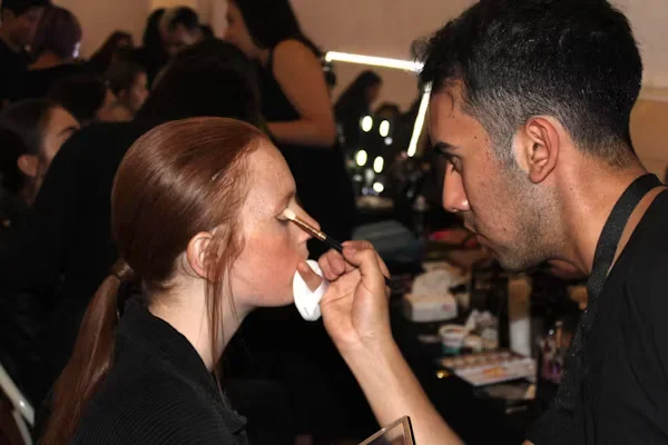 Career Paths in Cosmetology: From Salon Chair to Beyond a man doing makeup on female model