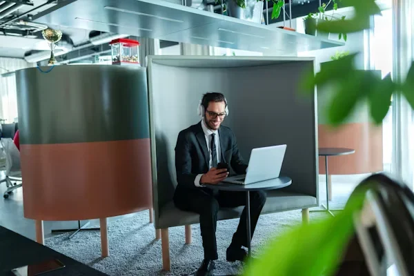 a man sitting on a table using laptop