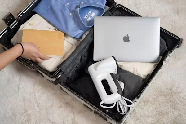 Gift Ideas for Travelers This Summer: 10 Gifts They'll Use a person packing luggage bags