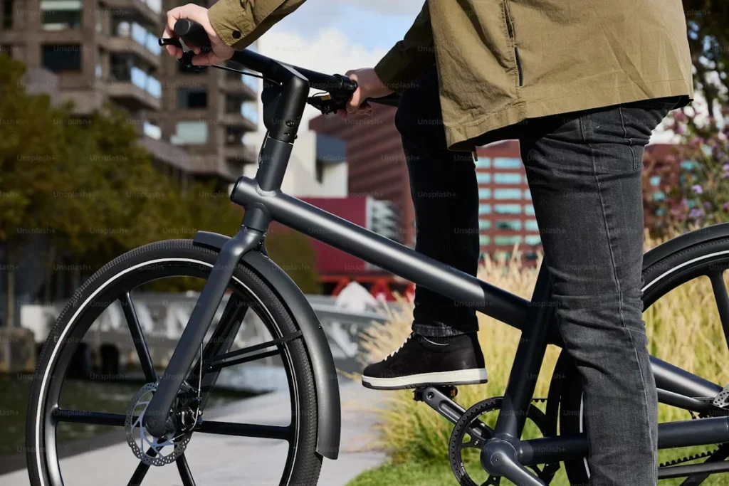 a person riding a bike on sidewalk
