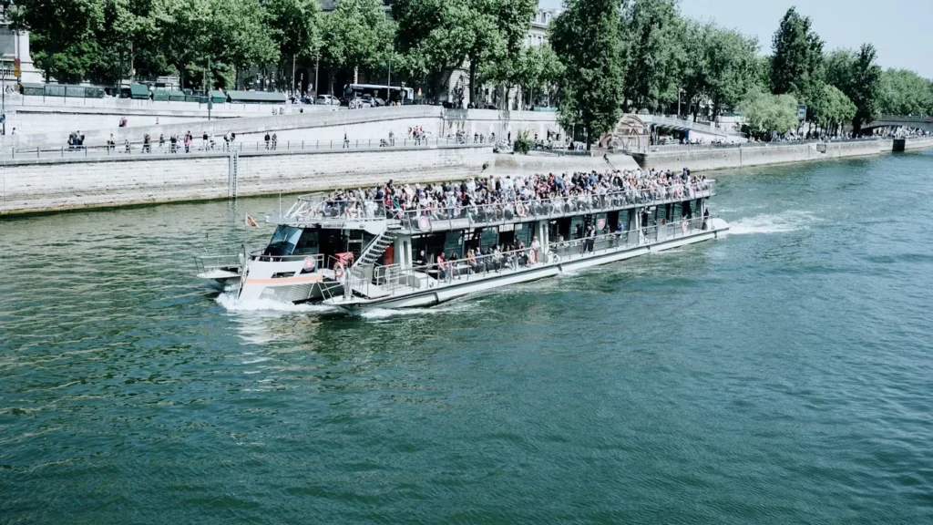 From Castles To Vineyards: What You’ll See On A River Cruise a tourist boat cruises on the seine river
