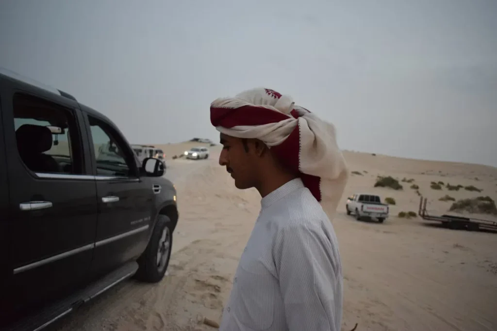 man standing near a car.