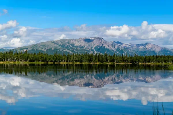 How to Plan the Perfect Proposal in Alaska mountain and blue body of water under cloudy sky