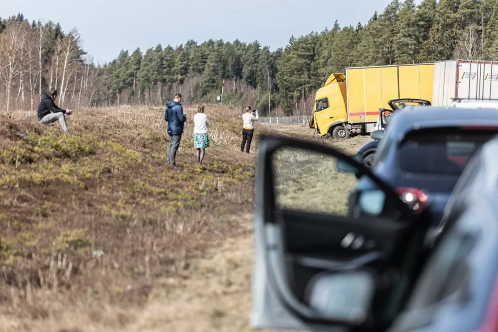 Why Truck Accident Cases Are Often More Complicated Than Car Accidents people investigate an accident near the roadside.